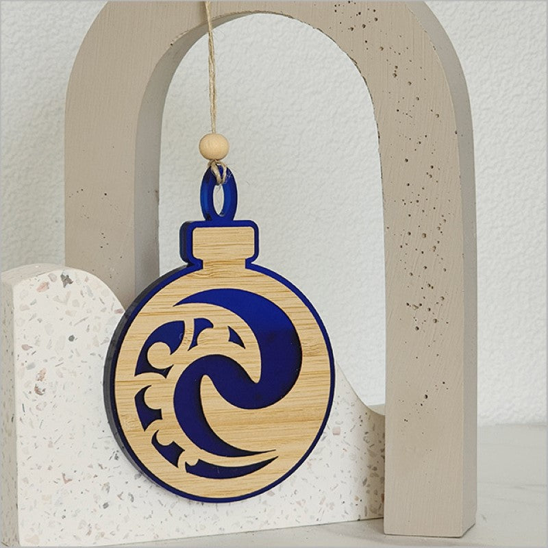 Blue satin acrylic hanging ornament featuring a Koru design, perfect for holiday decor or thoughtful gifts.