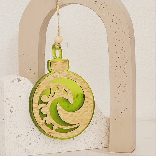 Vibrant lime satin acrylic bauble ornament featuring a Koru design, perfect for decorative and gift purposes.