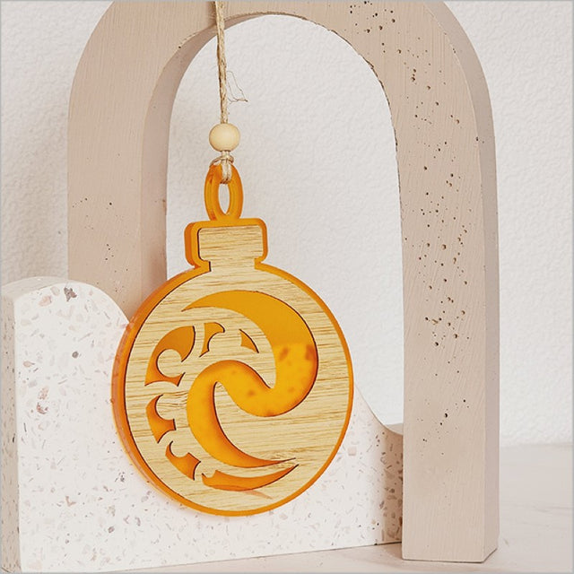 Orange satin acrylic Koru ornament, 80mm x 110mm, ideal for festive decor and gifting, combines artistry with modern elegance.