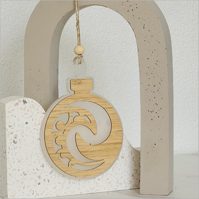 White satin acrylic hanging ornament in Koru design, 80mm x 110mm, laser-cut bamboo ready to hang.