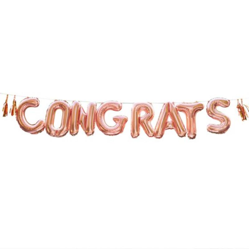 Rose gold 'CONGRATS' balloon bunting with tassels, perfect for celebrations and adding elegance to any event.