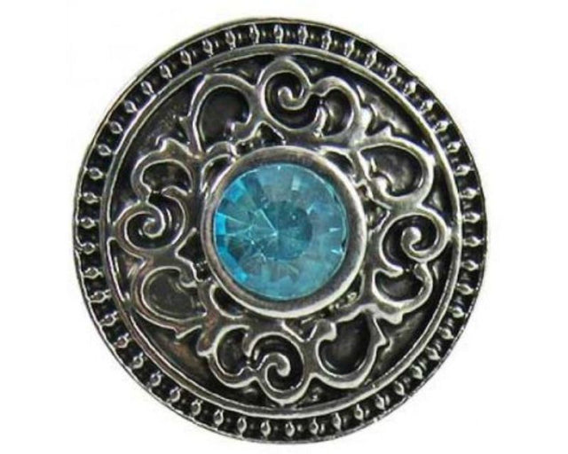 Celtic-inspired snap featuring intricate design and sparkling blue crystal, ideal for enhancing your jewelry collection.