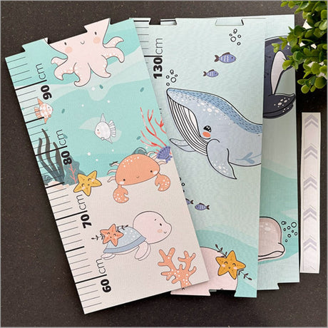 Colorful patchwork sea life growth chart ruler on textured MDF, featuring puzzle pieces and markers for tracking child’s height.