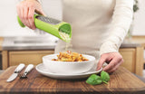 Zeal Tower Grater in vibrant red or green, designed for mess-free cheese grating and easy pouring directly onto dishes.