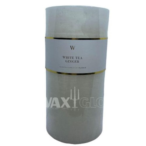 White cylinder Waxglo Scented Candle with notes of white tea and ginger, promising up to 120 hours of fragrant ambiance.