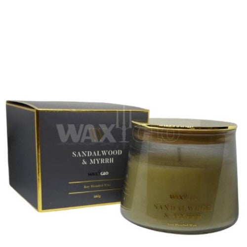 Waxglo Scented Candle in elegant glass jar, featuring sandalwood and myrrh aromas for up to 36 hours of cozy ambiance.