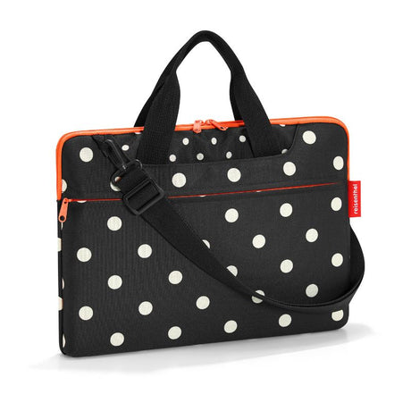 Stylish Reisenthel netbook bag in Mixed Dots, padded for 15.6-inch notebooks with multiple pockets and adjustable strap.