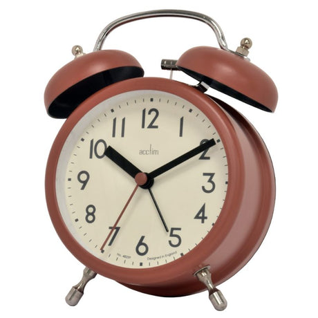 Soft coral double bell alarm clock with chrome accents and glass lens, perfect for retro-style bedroom decor.