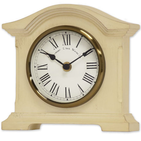 Cream mantel clock with vintage design, antique brass bezel, Roman dial, and quartz movement for accurate timekeeping.