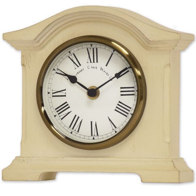 Cream mantel clock with vintage design, antique brass bezel, Roman dial, and quartz movement for accurate timekeeping.