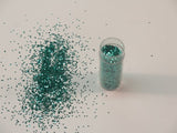 Aqua glitter from Das, 1/24" size, ideal for scrapbooking and crafts, adds vibrant shimmer to artistic projects.