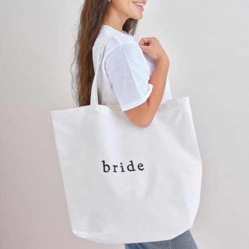 Stylish white cotton tote bag for hen parties, spacious, durable handles, perfect for carrying essentials and gifts.