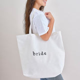 Stylish white cotton tote bag for hen parties, spacious, durable handles, perfect for carrying essentials and gifts.