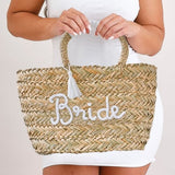 Stylish rattan bag for brides, featuring 'Bride' lettering and white tassels, perfect for hen party essentials.