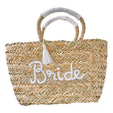 Stylish rattan bag for brides, featuring 'Bride' lettering and tassels, perfect for hen parties and celebrations.