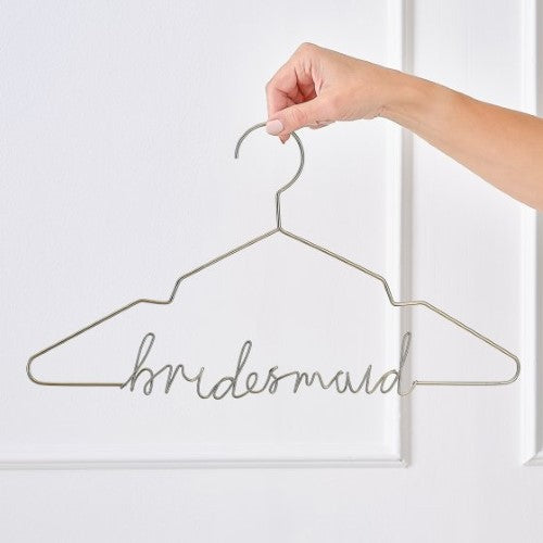 Elegant gold bridesmaid hanger with sleek design, perfect for displaying dresses and gifting to friends.