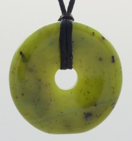 Elegant jade donut pendant on a black adjustable cord, symbolizing harmony and wellness, 34mm in diameter.