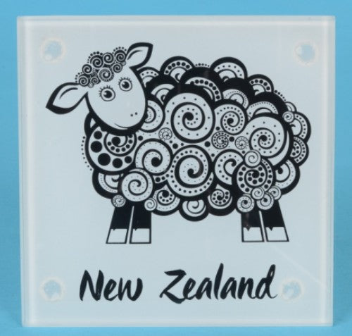 Set of four tempered glass coasters featuring unique Koru sheep designs, ideal for home decor and gift giving.