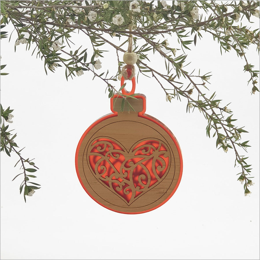 Vibrant red acrylic heart hanging ornament, intricately laser-cut, perfect for festive décor or as a thoughtful gift.
