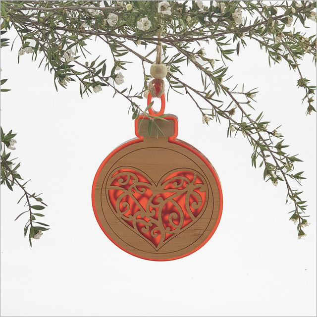 Vibrant red acrylic heart hanging ornament, intricately laser-cut, perfect for festive décor or as a thoughtful gift.