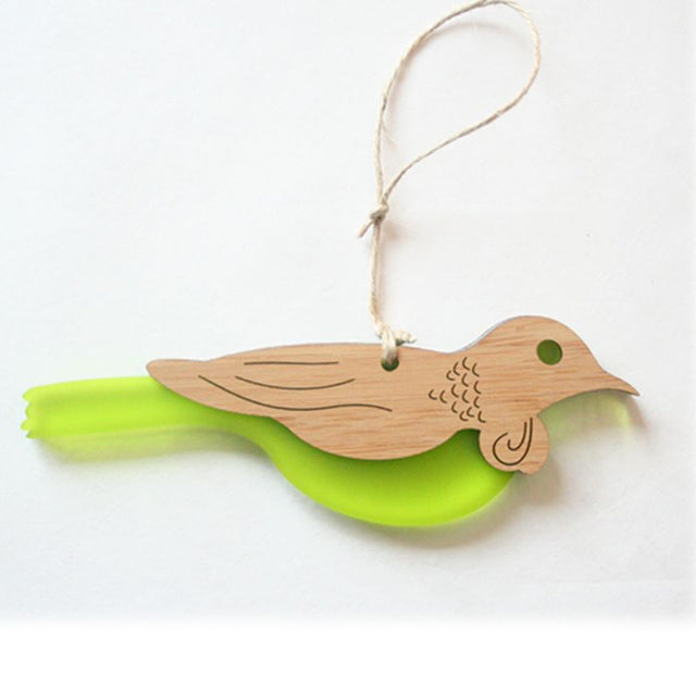 Elegant Tui hanging ornament made of bamboo and lime green satin acrylic, featuring intricate laser-cut designs.