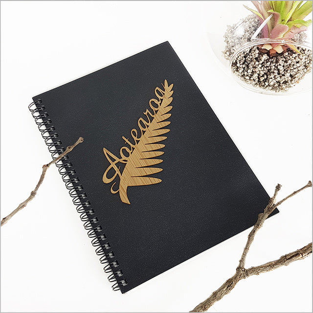 A5 journal with a black fern design, featuring 120 pages of smooth acid-free paper for writing and sketching.