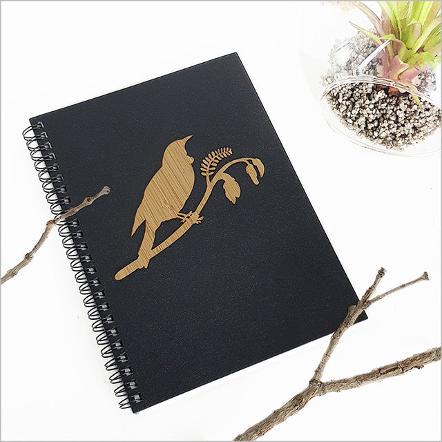 A5 journal featuring a Tui bird on a Kowhai branch, perfect for writing and sketching with premium acid-free paper.