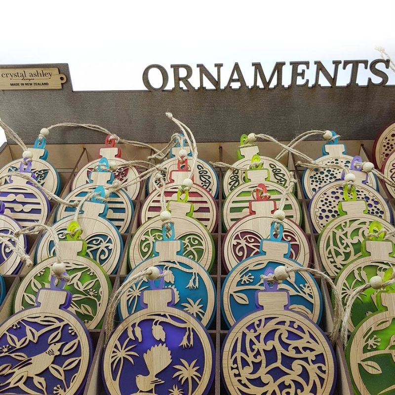 Teal acrylic bauble ornament featuring a fantail on a kowhai branch, perfect for modern home decor.
