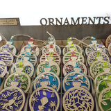 Teal acrylic bauble ornament featuring a fantail on a kowhai branch, perfect for modern home decor.
