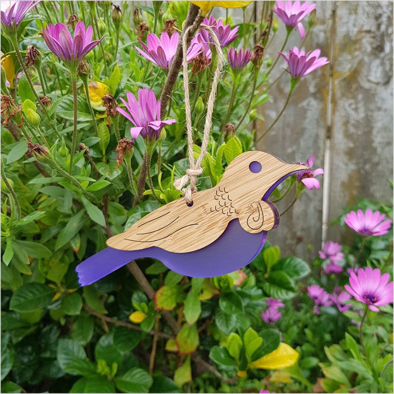 Hanging Tui ornament crafted from bamboo with purple satin acrylic, perfect for home decor and easy to hang.