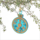Teal acrylic bauble ornament featuring a fantail on a kowhai branch, showcasing New Zealand's nature, perfect for home decor.