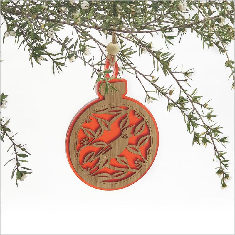 Red acrylic bauble featuring a laser-cut Tui on a Pohutukawa branch, perfect for festive decorations.