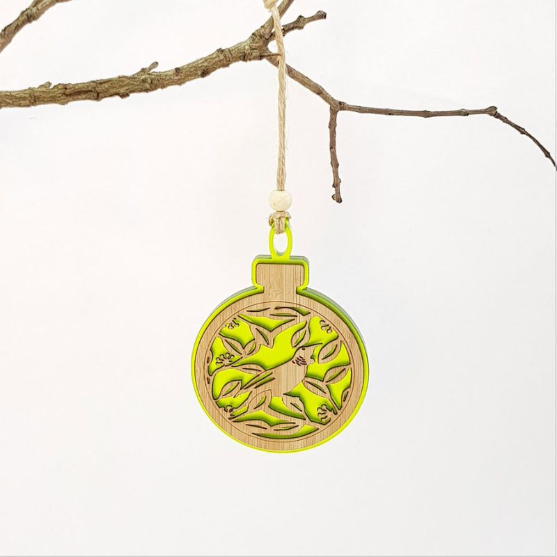 Lime green acrylic bauble featuring a tui on pohutukawa, perfect for festive decor and gifts.