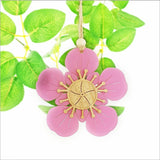 Pink satin acrylic Manuka flower ornament with intricate laser cut design, perfect for home decor or seasonal displays.