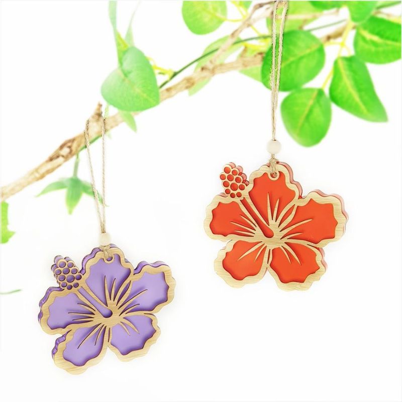 Red satin acrylic hibiscus ornament with intricate laser-cut details, perfect for home decor and holiday celebrations.