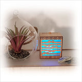 Koru LED tealight candle box in laser-cut bamboo, features color-changing LED candle for serene ambiance.