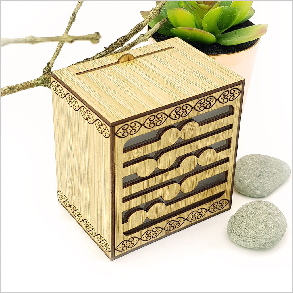 Koru LED Tealight Candle Box in laser-cut bamboo, featuring color-changing LED tealight for a soothing decor ambiance.