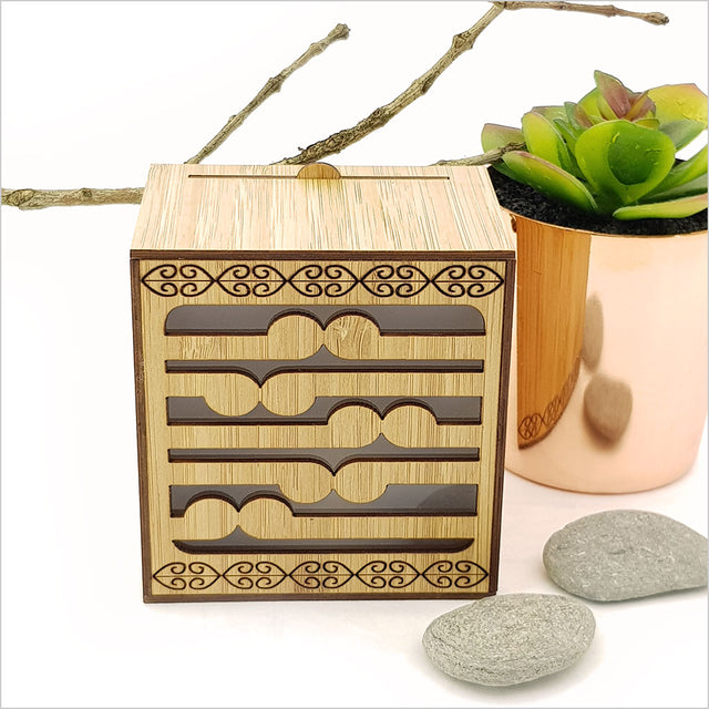 Koru LED tealight candle box in laser-cut bamboo with color-changing candle; a beautiful, safe decor piece that can hang on the wall.