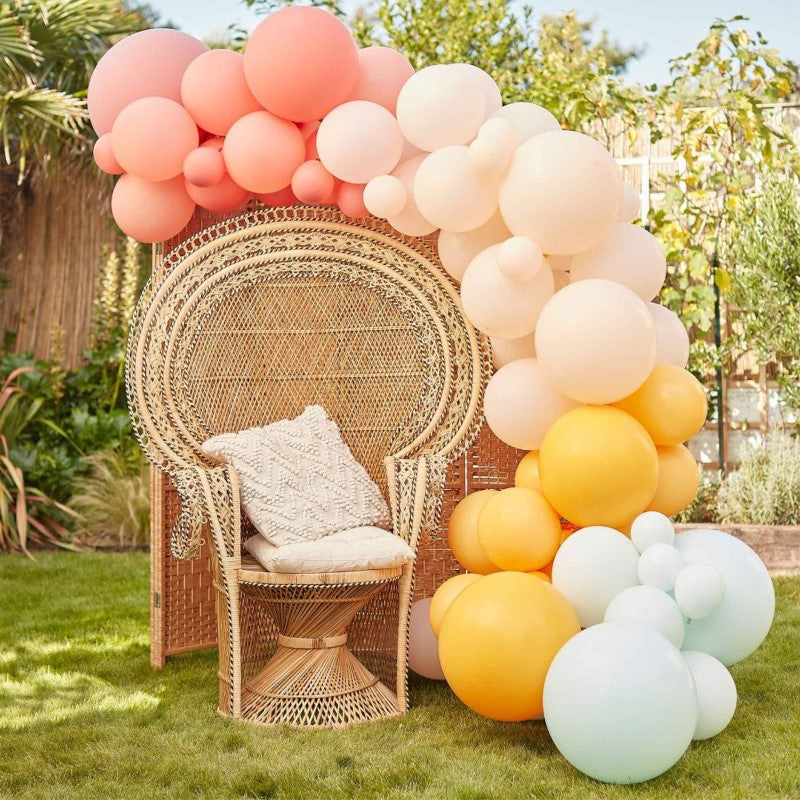 Muted pastel balloon arch kit featuring 75 latex balloons in coral, pink, peach, yellow, and mint green for celebrations.