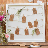 Rustic country guest book frame with pegs, twine, and tags for heartfelt messages, ideal for weddings and celebrations.