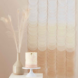 Neutral ombre tissue paper disc backdrop, 1.8m tall, featuring 18 cascading discs for elegant party decor.