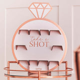 Rose gold drinks shot wall decorated for a hen party, featuring holders for shots and a stylish design.