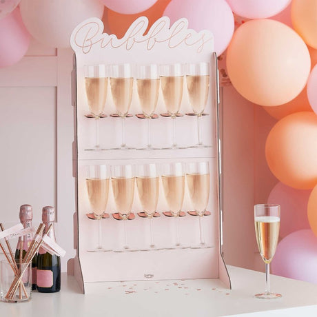 Elegant rose gold foiled prosecco wall for Bachelorette parties, featuring space for 10 bottles and chic design.