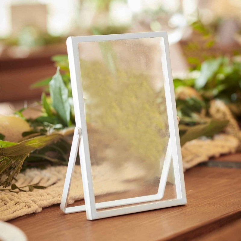 Elegant white metal and glass photo frame, perfect for showcasing cherished memories or table numbers at events.
