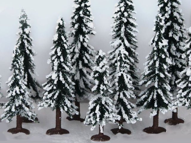 A pack of 12 snow-dusted evergreen pine trees, measuring 75-150mm, ideal for enhancing winter model landscapes.