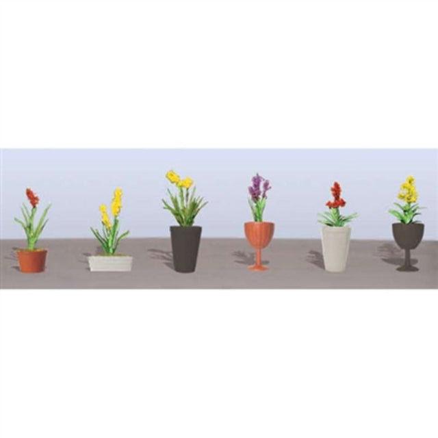 Assorted plant and flower models for O scale scenery, enhancing model landscapes and dioramas.