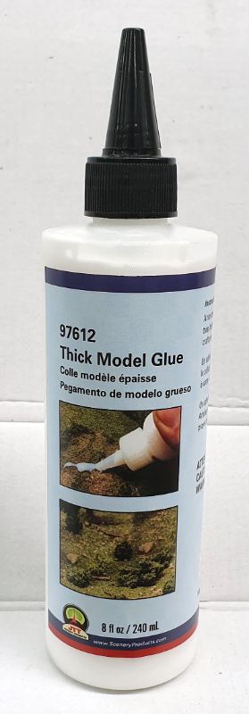 Thick model glue in 240ml bottle, ideal for secure bonding in model making and crafts.