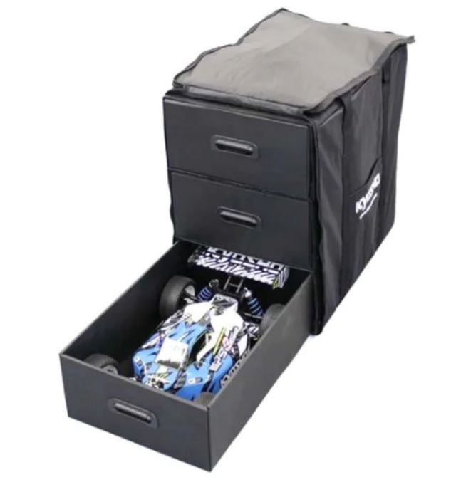 Large Kyosho carry bag for 1/8 RC vehicles, featuring padded handles, ample compartments, and durable materials for safe transport.