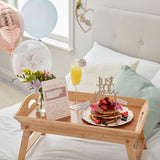 Customisable Breakfast in Bed Set featuring a scratch-to-reveal menu, drink topper, cake topper, and vibrant balloons.