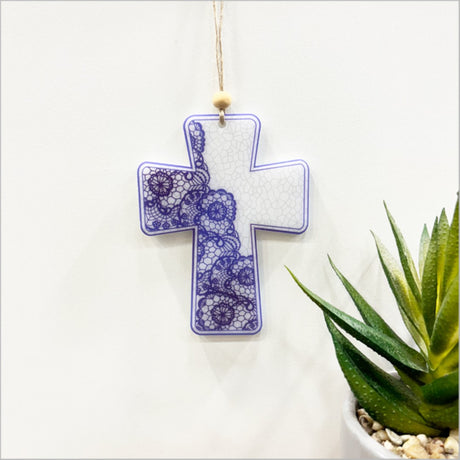Delicate lace-inspired hanging cross ornament in satin acrylic, measuring 89mm x 118mm, perfect for decor or gifts.